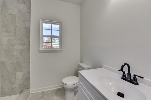 full bath with toilet, baseboards, and vanity