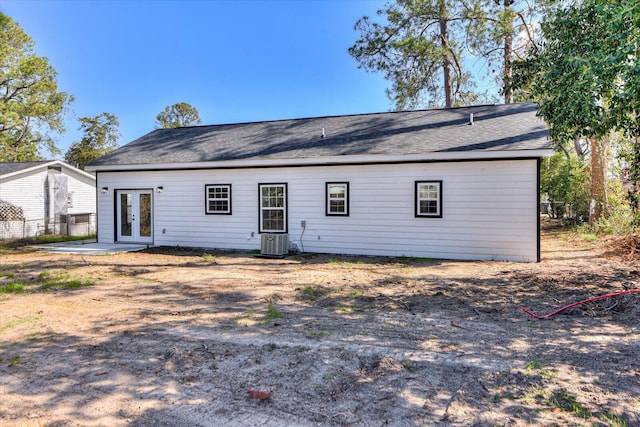 back of property with a patio, french doors, cooling unit, and fence