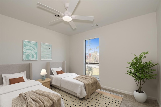 bedroom featuring visible vents, ceiling fan, light colored carpet, and baseboards