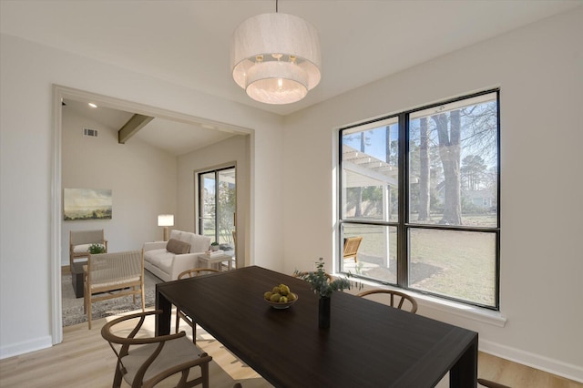 dining space with plenty of natural light, baseboards, and light wood-type flooring