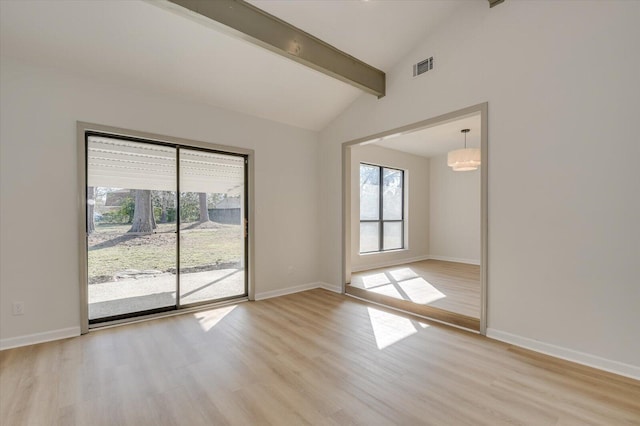 unfurnished room with beam ceiling, visible vents, baseboards, and light wood-style floors