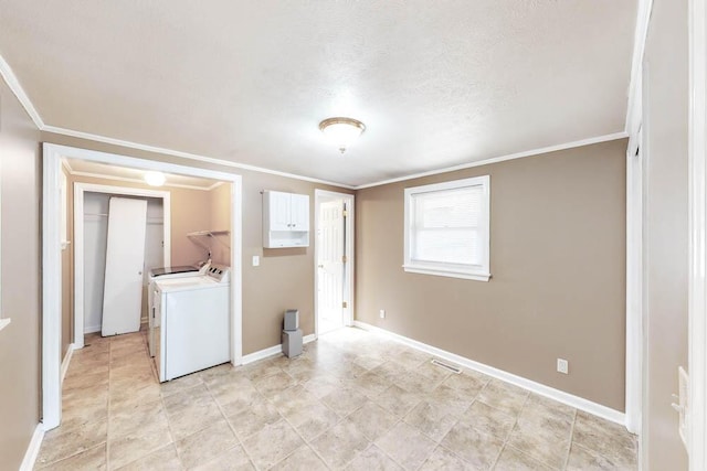 washroom featuring ornamental molding, separate washer and dryer, and a textured ceiling