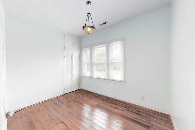 unfurnished room with hardwood / wood-style floors