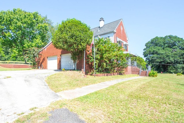 exterior space featuring a garage and a front lawn