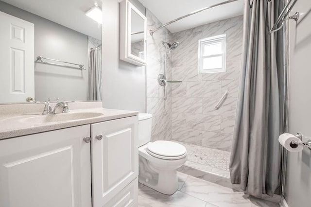 bathroom featuring walk in shower, vanity, and toilet