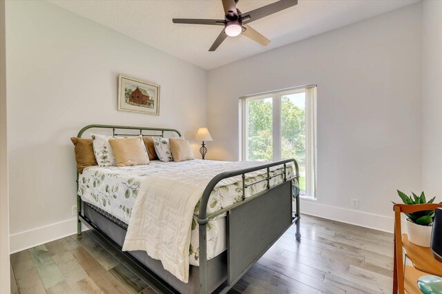 bedroom with hardwood / wood-style flooring and ceiling fan