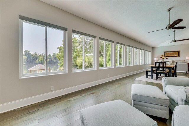 sunroom with vaulted ceiling, ceiling fan, and a healthy amount of sunlight