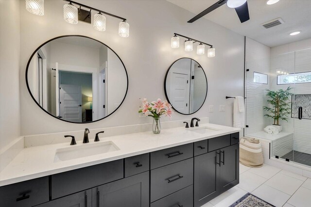 bathroom with tile patterned flooring, ceiling fan, walk in shower, and vanity