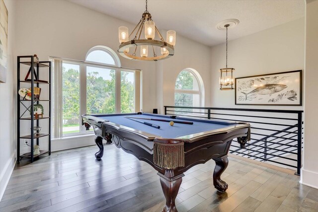 game room featuring a healthy amount of sunlight, wood-type flooring, and billiards