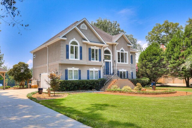 view of front facade with a garage and a front lawn