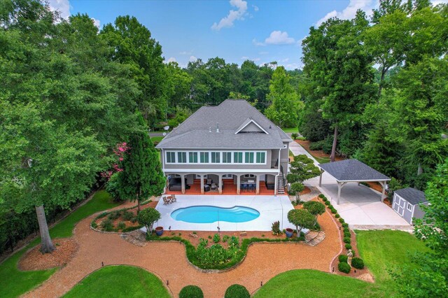 back of house with a carport and a patio