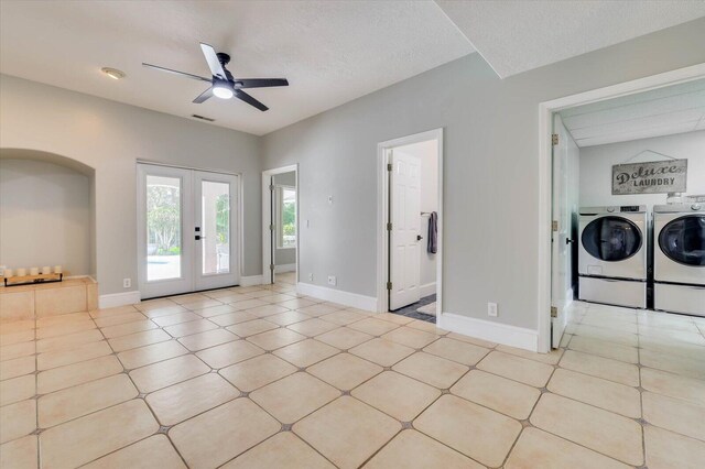 interior space with washing machine and dryer, ceiling fan, french doors, and a textured ceiling