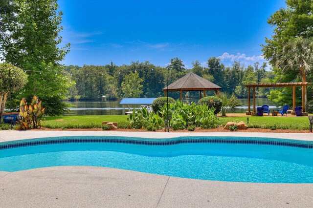 view of swimming pool with a gazebo, a yard, a water view, and a pergola