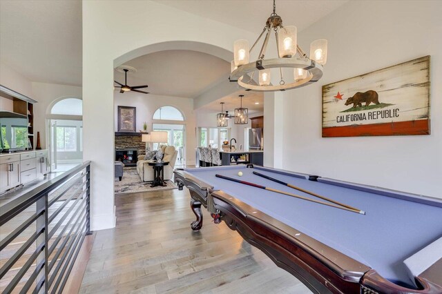 rec room featuring a fireplace, hardwood / wood-style floors, ceiling fan, and billiards