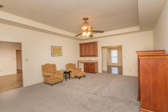 2114 Southlake Pkwy, Augusta, GA 30906 - living area with carpet, a ceiling fan, a raised ceiling, and a textured ceiling