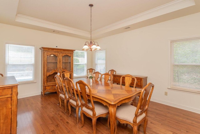 2114 Southlake Pkwy, Augusta, GA 30906 - dining area featuring a tray ceiling, crown molding, wood finished floors, and a chandelier
