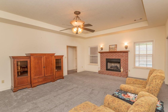 2114 Southlake Pkwy, Augusta, GA 30906 - living room featuring light carpet, ceiling fan, a fireplace, and a tray ceiling