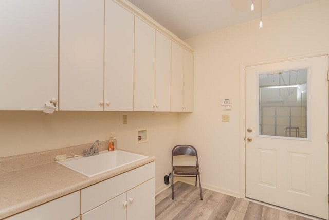 2114 Southlake Pkwy, Augusta, GA 30906 - laundry area featuring cabinet space, light wood finished floors, and washer hookup