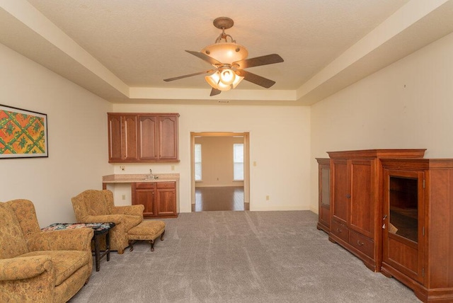 2114 Southlake Pkwy, Augusta, GA 30906 - living area with a raised ceiling, light colored carpet, and a ceiling fan