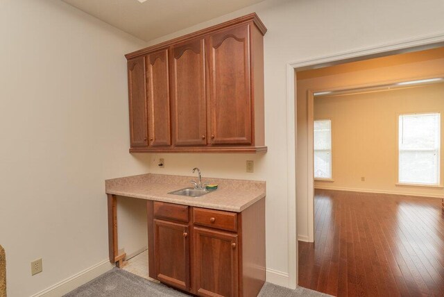 2114 Southlake Pkwy, Augusta, GA 30906 - kitchen featuring light countertops, light wood-style flooring, and brown cabinets