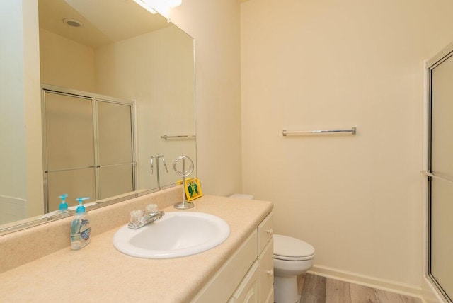 2114 Southlake Pkwy, Augusta, GA 30906 - full bathroom with a shower with shower door, vanity, and wood finished floors