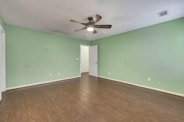 spare room featuring ceiling fan and dark wood-type flooring