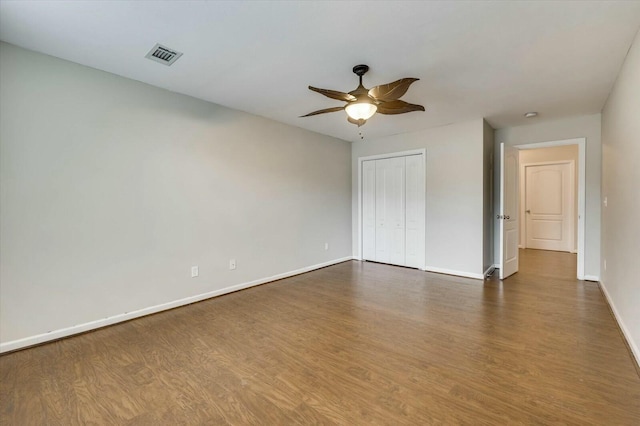 interior space featuring ceiling fan and dark wood-type flooring