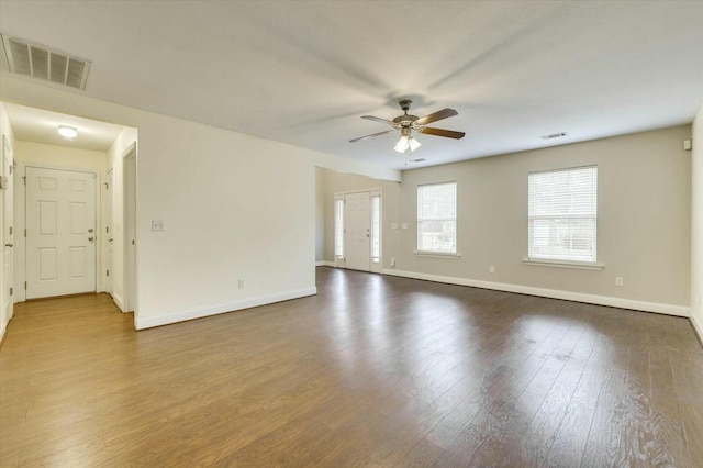 empty room with ceiling fan and dark hardwood / wood-style floors