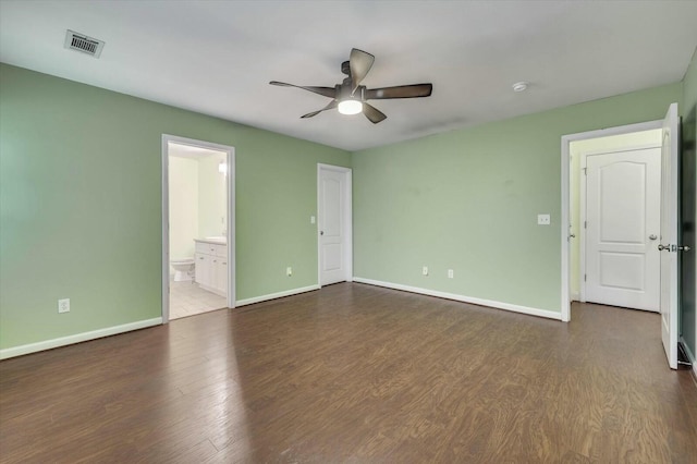 spare room with ceiling fan and dark hardwood / wood-style floors