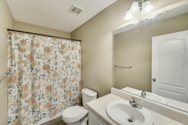 bathroom featuring vanity, curtained shower, and toilet