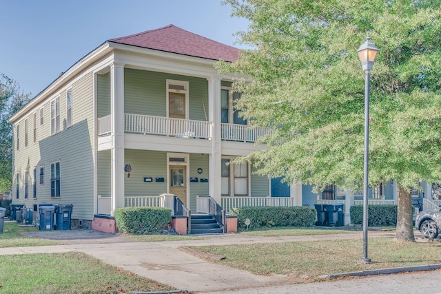 multi unit property with covered porch and a balcony