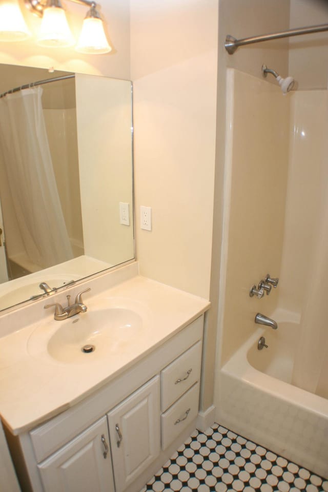 bathroom with tile patterned flooring, shower / bathtub combination with curtain, and vanity