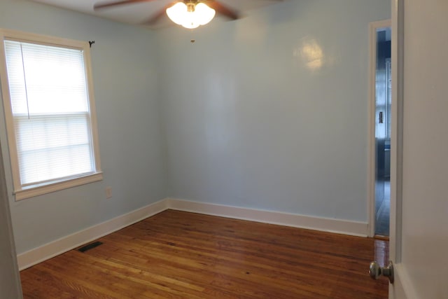 unfurnished room with ceiling fan and dark hardwood / wood-style floors