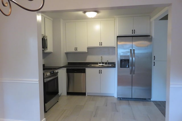 kitchen with sink, white cabinets, and stainless steel appliances