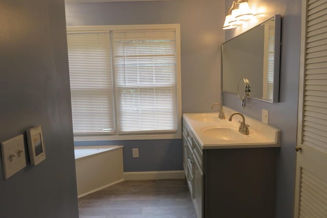 bathroom featuring hardwood / wood-style floors, vanity, and plenty of natural light