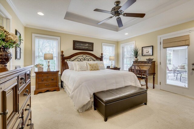 carpeted bedroom featuring ceiling fan, access to exterior, ornamental molding, and a tray ceiling