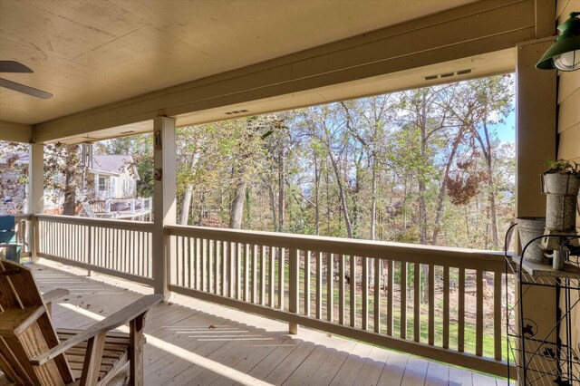 wooden terrace featuring ceiling fan