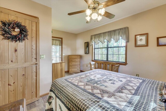 bedroom with ceiling fan and light wood-type flooring