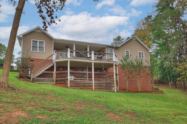 back of house featuring a lawn and ceiling fan