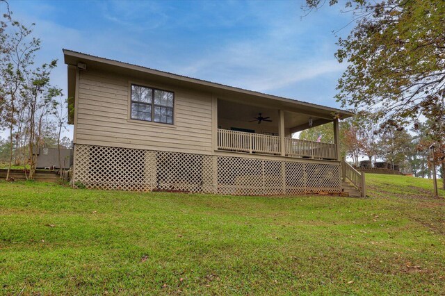 view of home's exterior with a lawn, ceiling fan, and covered porch