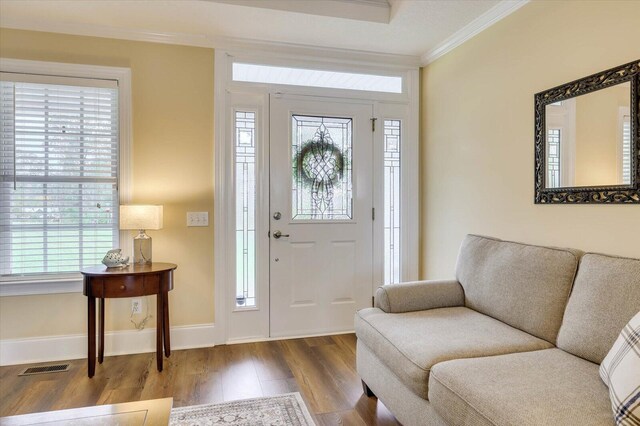 entryway featuring hardwood / wood-style floors and ornamental molding