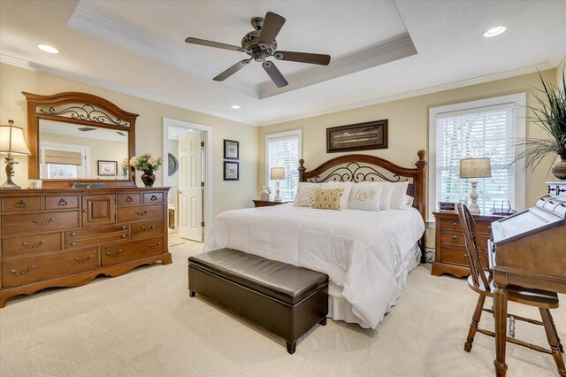 carpeted bedroom featuring a raised ceiling, multiple windows, ceiling fan, and crown molding