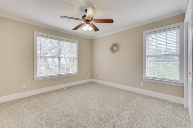 unfurnished room with ceiling fan, a healthy amount of sunlight, ornamental molding, and carpet floors