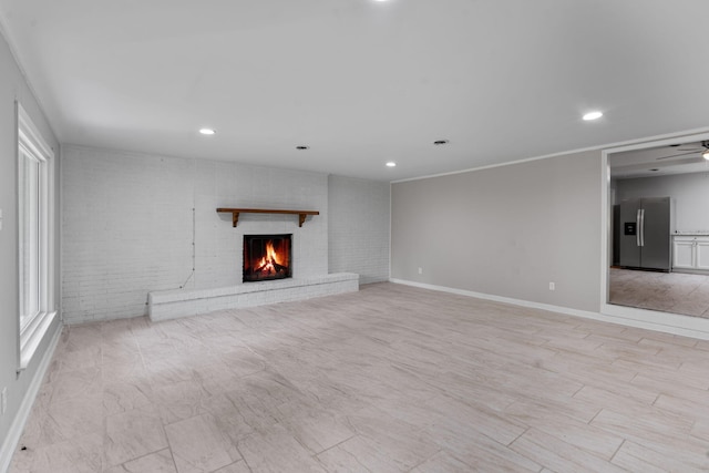 108 Frances Dr, North Augusta, SC 29841 - unfurnished living room featuring brick wall, a fireplace, recessed lighting, and a ceiling fan