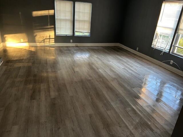 empty room with dark hardwood / wood-style floors