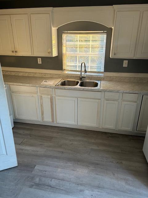 kitchen featuring white cabinetry, sink, and dark hardwood / wood-style floors