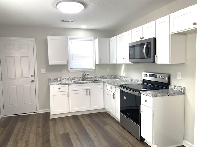 2113 Dyer St, Augusta, GA 30901 - kitchen with stainless steel appliances, a sink, and white cabinetry