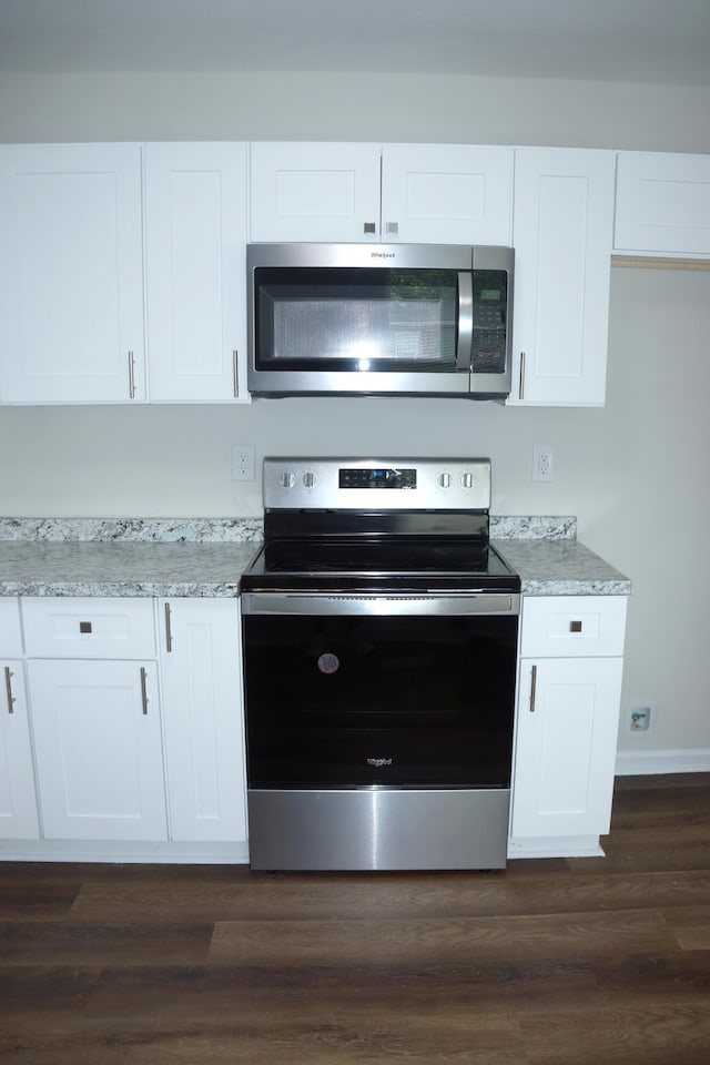 2113 Dyer St, Augusta, GA 30901 - kitchen featuring stainless steel appliances, white cabinetry, dark wood-type flooring, and baseboards