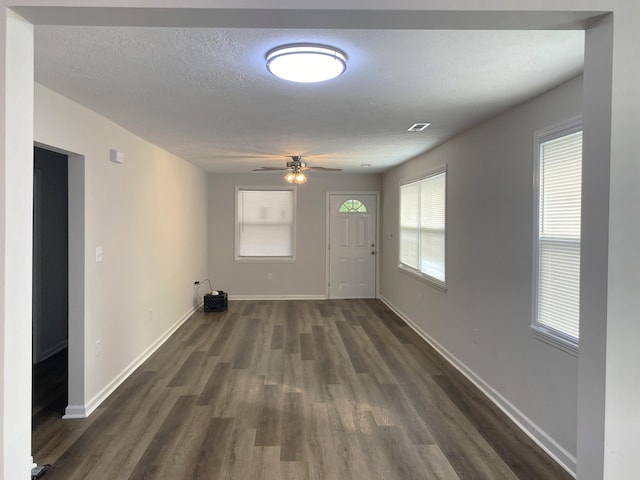 2113 Dyer St, Augusta, GA 30901 - unfurnished living room featuring dark wood-style flooring, a ceiling fan, baseboards, and a textured ceiling