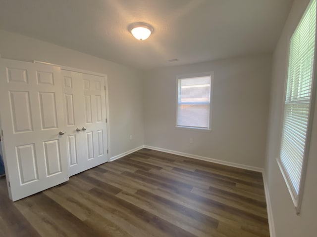 2113 Dyer St, Augusta, GA 30901 - unfurnished bedroom with dark wood-type flooring, baseboards, and a closet